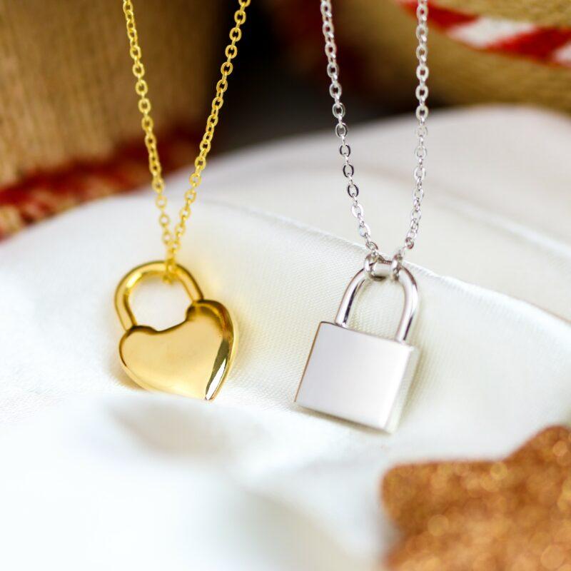 Christmas gifts for friends. Image shows to engravable necklaces on a Christmas backdrop.